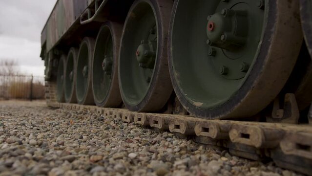 Low shot of tank tracks on gravel