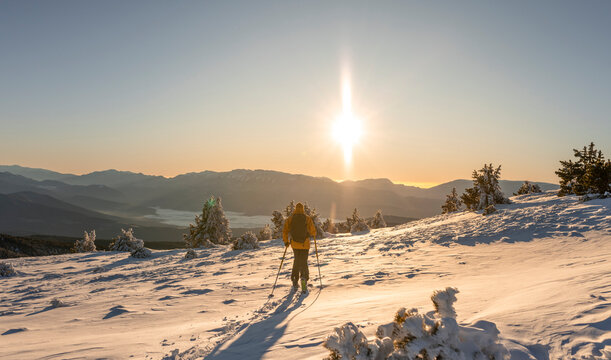 Man doing ski touring at sunrise