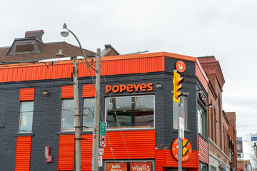 Fototapeta premium exterior and sign of Popeyes Louisiana Kitchen, a chicken restaurant chain, located at 2221 Bloor Street West in Toronto, Canada