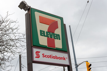 Fototapeta premium exterior pylon sign of 7-Eleven, a convenience store chain, located here at 3355 Dundas Street West in Toronto, Canada