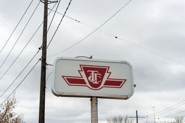 Fototapeta premium TTC logo sign on a cloudy sky located at Runnymede Road and Dundas Street West loop in Toronto, Canada