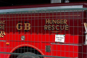 Obraz premium through a barrier fence shot of an old firetruck with text at Evergreen Brick Works in Toronto, Canada