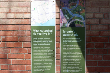 Obraz premium two information panels on a brick wall (featuring details about waterways and watersheds) in Toronto, Canada (Evergreen Brick Works)