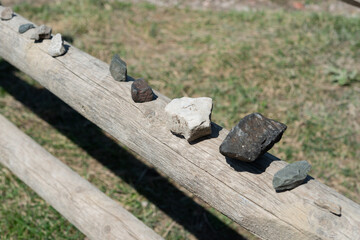 stones on a wood fence