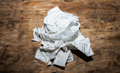 Paper Ball With Invoices On A Desk.