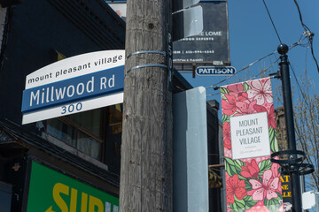 Fototapeta premium City of Toronto street sign at Millwood Road and BIA hanging banner sign