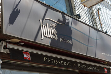 Fototapeta premium exterior sign of Jules Cafe Patisserie, a bakery, located at 617 Mount Pleasant Road in Toronto, Canada