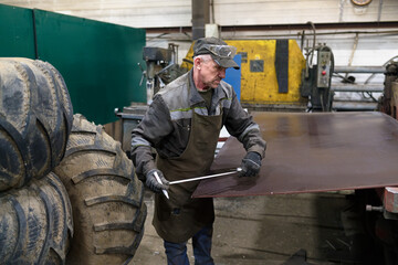 factory worker measuring detail