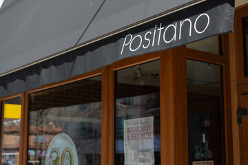 Fototapeta premium exterior awning sign and facade of Positano, a southern Italian restaurant, located at 633 Mount Pleasant Road in Toronto, Canada