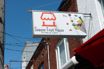 Fototapeta premium exterior projecting sign of Season Fruit House, a grocery store, located at 679 Mount Pleasant Road in Toronto, Canada
