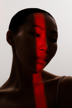 Studio portrait of asian woman looking straight to the camera 
