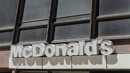 Fototapeta premium exterior building and sign of McDonald's, a fast food restaurant chain, here located at 20 Eglinton Avenue East in Toronto, Canada