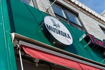 Obraz premium exterior round Muskoka Brewery sign at The Abbot, a gastropub, located at 508 Eglinton Avenue West in Toronto, Canada