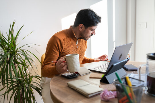 Man reviewing household finances and bills at home.