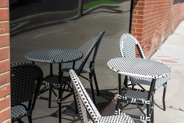bistro table and chairs on a sidewalk
