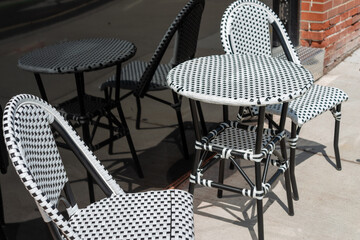 bistro table and chairs set outside on a sidewalk