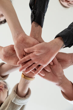 Team of crop colleague stacking hands together