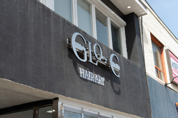 Naklejka premium exterior building facade and sign of Glo-C Hair Art, a hair salon, located at 1120 Eglinton Avenue West in Toronto, Canada