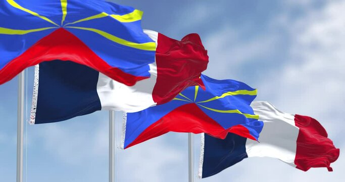 Reunion and national french flags waving in the wind on a clear day