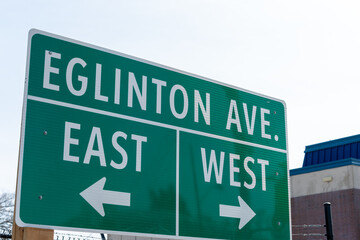 highway sign at Eglinton Avenue West (and the Allen Expressway) with arrows pointing east and west in Toronto, Canada