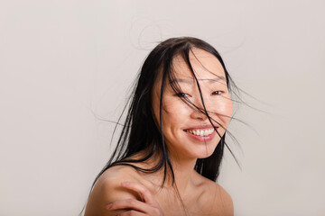 Woman with natural make up posing on white background in studio 