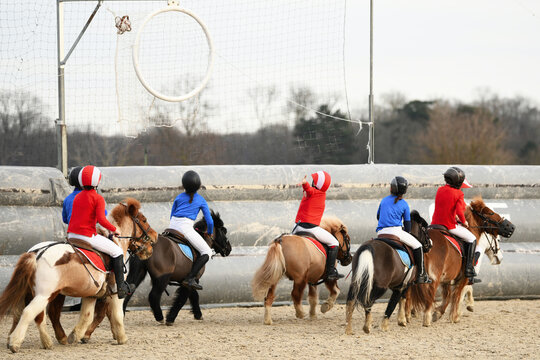 Children on ponys playing horseball