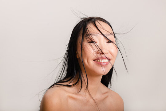 Happy asian woman with studio light 