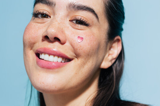 Portrait of a woman with a heart on her cheek