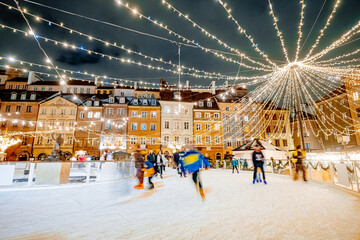 A beautiful crowded outdoor ice rink in the old European city