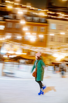 Winter ice skating on an outdoor ice rink in beautiful evening lights