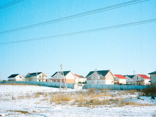 Analog image of countryside houses in the snow 