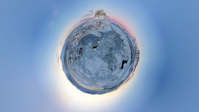 Greenland village in sea-ice - little planet tiny world drone shot