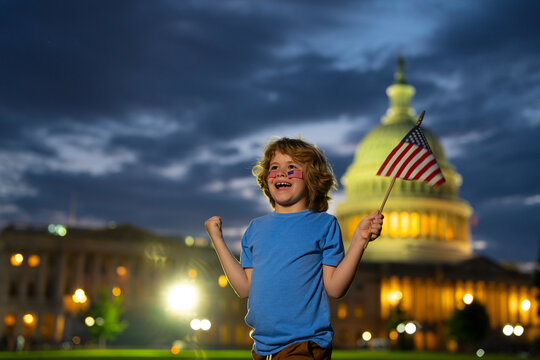 Excited child hold American flag. Patriotic holiday. Kid boy with American flag in Washington DC. USA kids celebrate independence day 4th of July. Portrait of American child with American Flag.