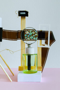 Abstract still life with with film, sparkles on a pink background
