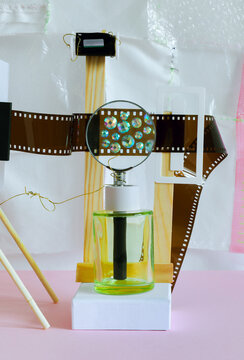 Abstract still life with with film, sparkles on a pink background