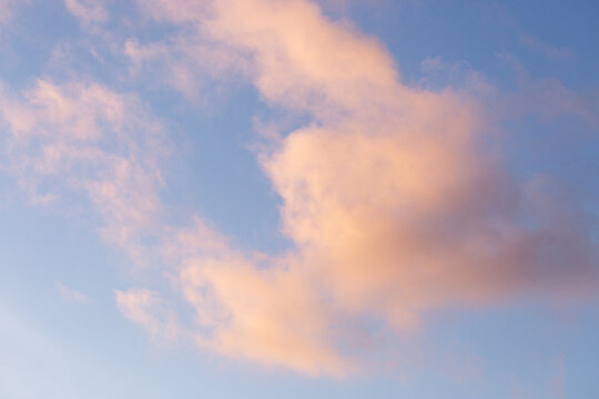 Peachy clouds in a blue sky