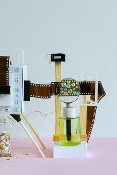 Abstract still life with with film, sparkles on a pink background
