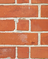 Obraz premium Orange, brick and wall texture with rough pattern, concrete background and masonry in architecture. Cracked, detail and building wallpaper with space for material, cement and construction design