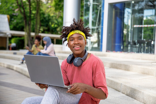 Portrait of student with laptop in college campus