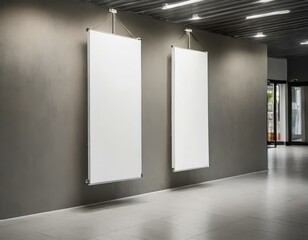 Two blank white vertical banners are hanging on a wall, ready for customization and display