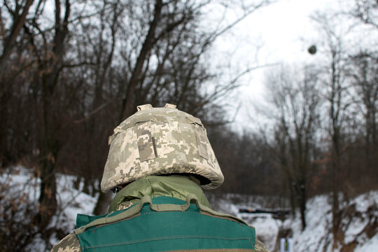 Back view of a soldier head in protective helmet