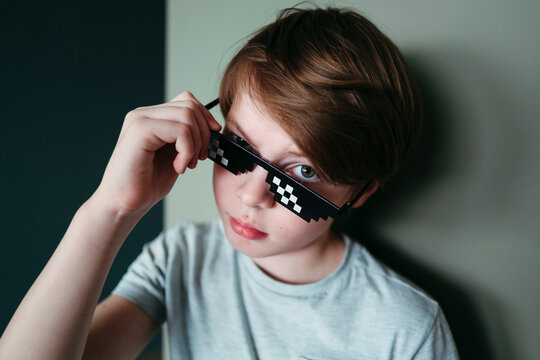 Disaffected boy in pixel sunglasses.