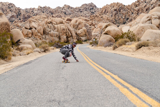 Skateboarder in motion on road
