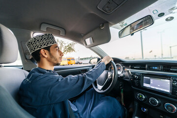 Arab man driving modern car in town