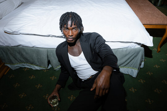 A man drinks alcohol indoors