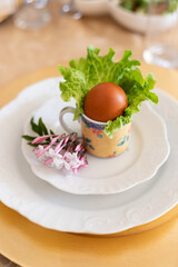 Boiled egg in shell decorating an Easter lunch table
