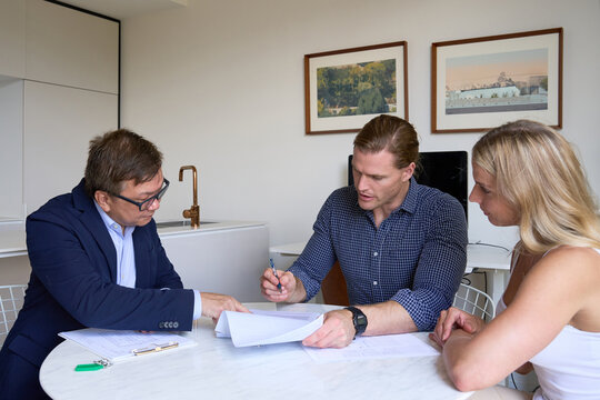 Buyers of property wth agent signing contract
