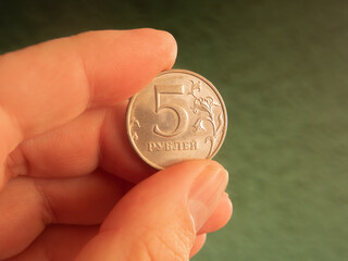 Close-up of a Hand Holding a Russian 5 Ruble Coin
