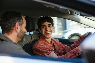 Father teaching his son to drive