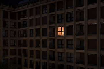 Lonely illuminated apartment window at night